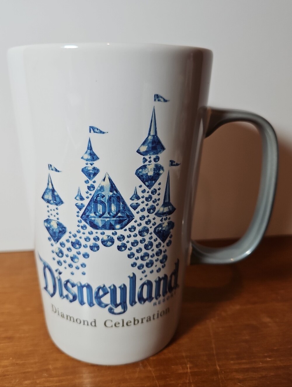 Disneyland 60th Diamond Celebration White Ceramic Mug with Blue Castle 16 Oz